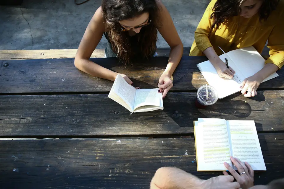 Students comparing course materials together