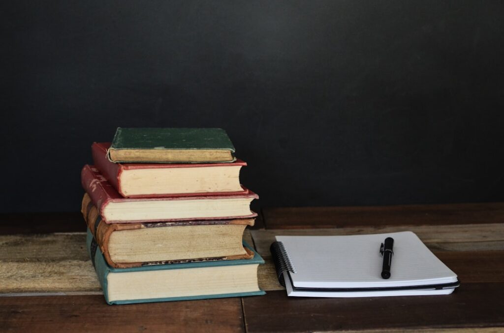 Stack of used textbooks on a desk